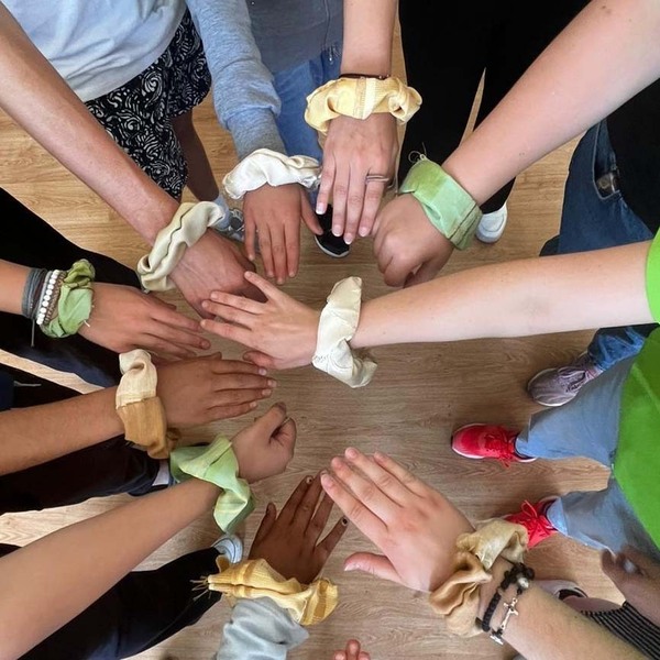 The Notre Dame volunteers and refugee children from Syria showing off the hair ties they made at the Vrzhdebna center for refugees in Sofia, Bulgaria.